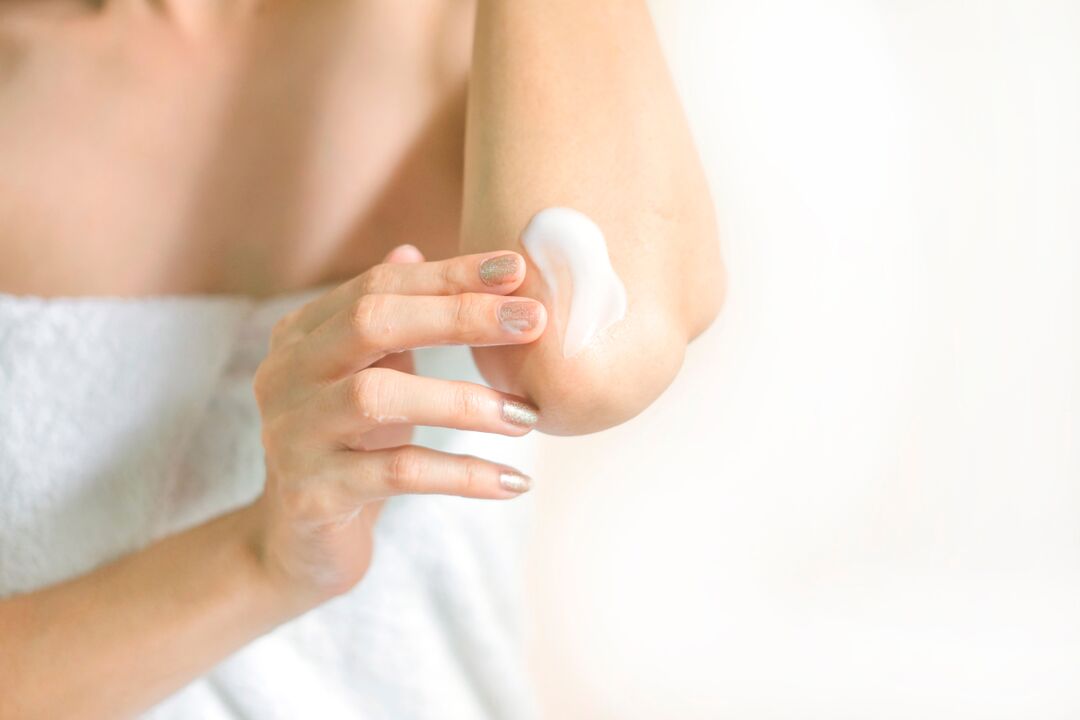 applying Depanten cream to the elbow joint